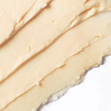 Load image into Gallery viewer, Close-up of a smooth, beige-colored cream or lotion on a white background
